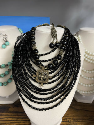 Traditional Ukrainian black necklace with brass crosses and angel pendant