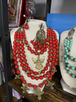 Traditional Ukrainian red coral necklace with brass crosses and angel pendant.