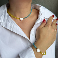 Set of blue and yellow jewelry with mother-of-pearl heart